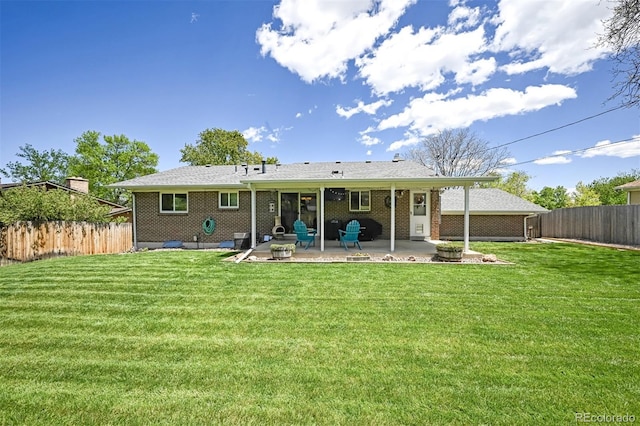 1733 S Urban Way, Lakewood, CO 80228 - back of house with a patio area and brick siding