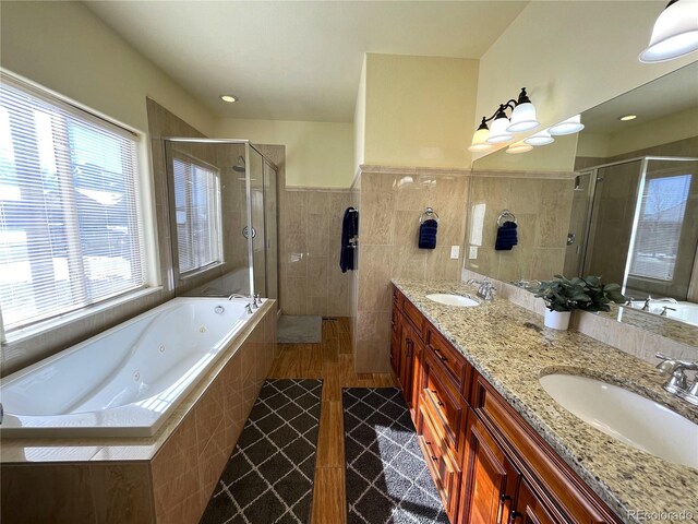 bathroom featuring independent shower and bath and vanity