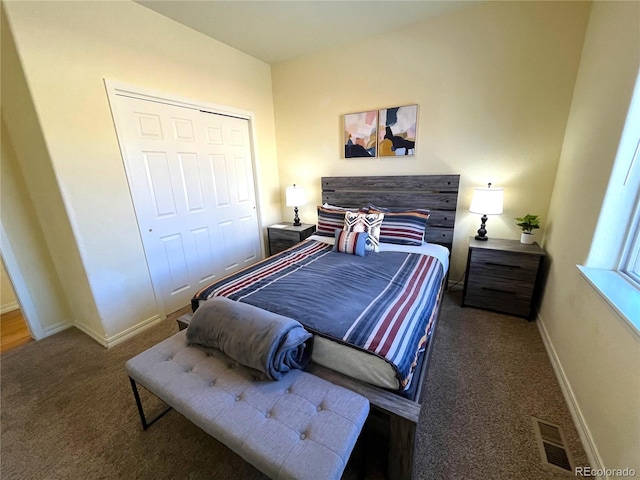 bedroom with a closet and dark colored carpet