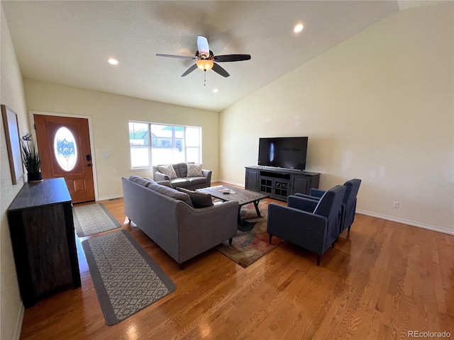 living room with hardwood / wood-style floors, ceiling fan, and high vaulted ceiling