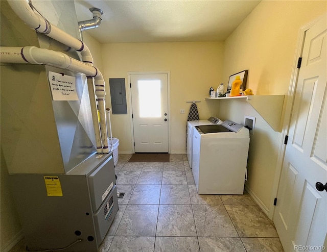 laundry area with electric panel, separate washer and dryer, and heating unit