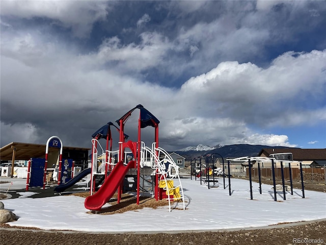 snow covered playground with a mountain view