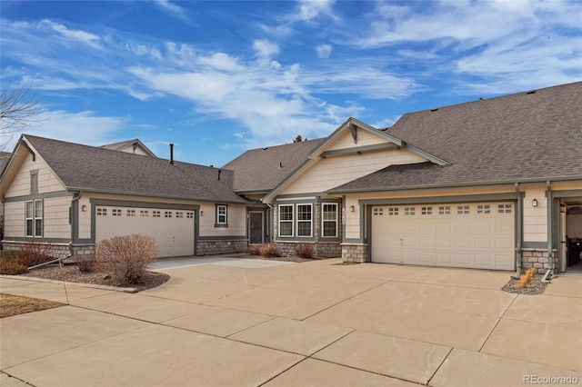 craftsman inspired home featuring stone siding, an attached garage, concrete driveway, and roof with shingles