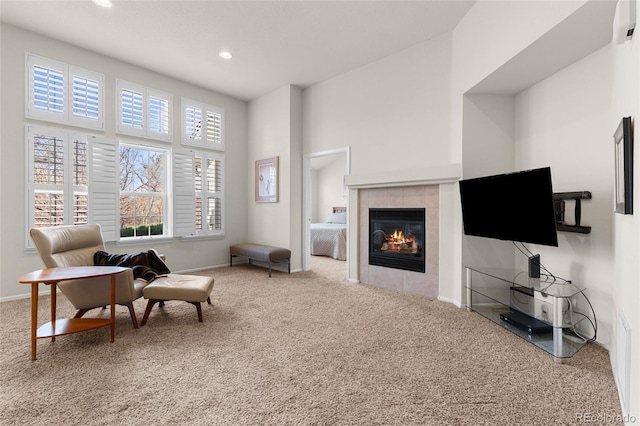 living area featuring recessed lighting, baseboards, carpet flooring, and a tiled fireplace