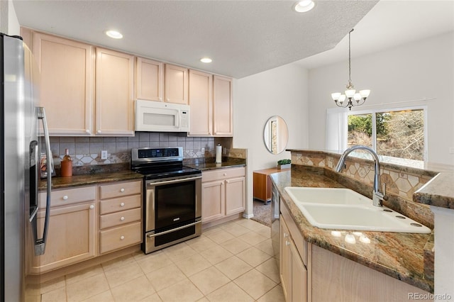 kitchen with light tile patterned floors, light brown cabinets, a sink, stainless steel appliances, and tasteful backsplash