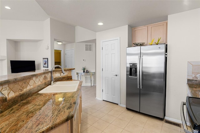 kitchen featuring visible vents, light brown cabinets, stainless steel fridge with ice dispenser, light tile patterned flooring, and a sink