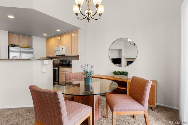 dining area with recessed lighting, baseboards, light colored carpet, and an inviting chandelier