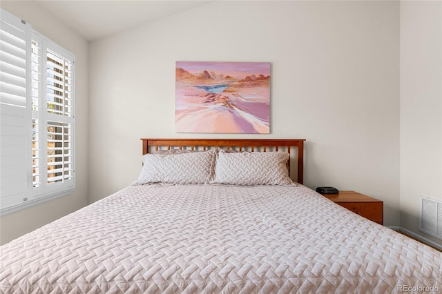 bedroom featuring visible vents and vaulted ceiling