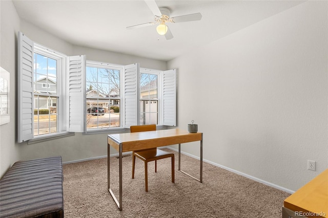 home office with baseboards, a ceiling fan, and carpet flooring