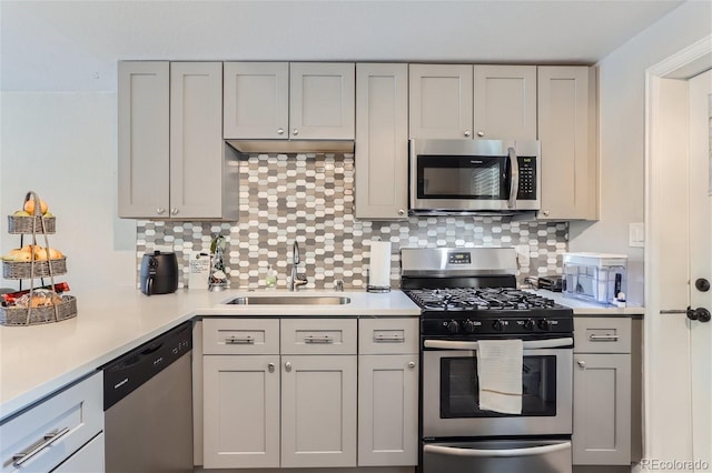 kitchen with sink, tasteful backsplash, and appliances with stainless steel finishes