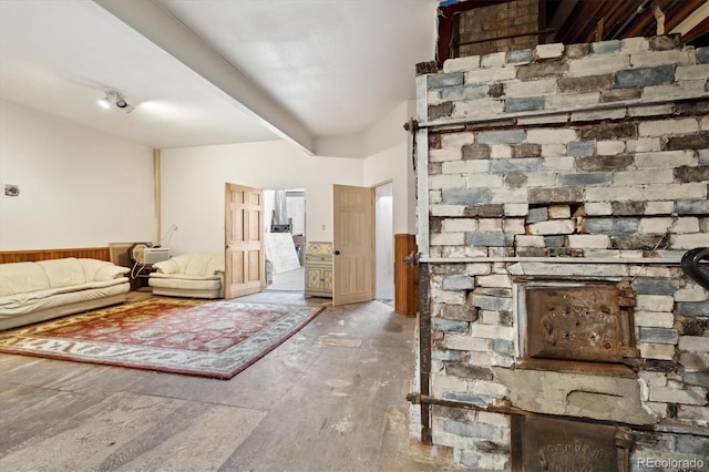 unfurnished living room with beamed ceiling