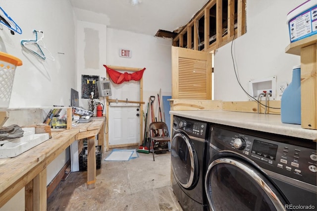 washroom featuring a workshop area and washer and clothes dryer