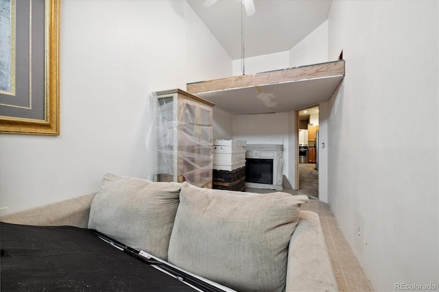 living room featuring ceiling fan and vaulted ceiling