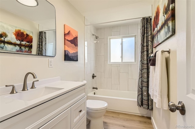 bathroom featuring vanity, toilet, wood finished floors, and shower / bath combo