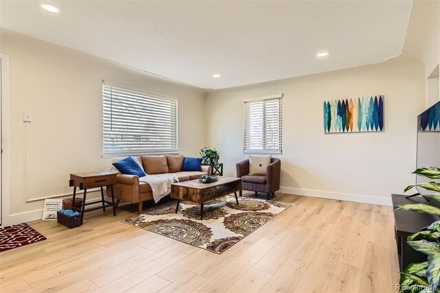 living area with recessed lighting, baseboards, and wood finished floors