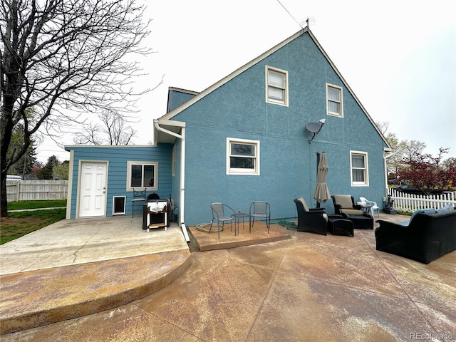 495 E Ave, Limon, CO 80828 - back of property featuring a patio, fence, outdoor lounge area, and stucco siding