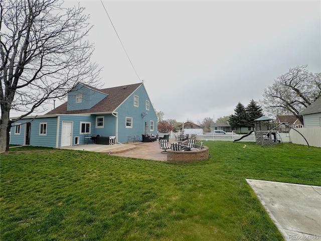 495 E Ave, Limon, CO 80828 - back of house with a playground, a patio, and roof with shingles