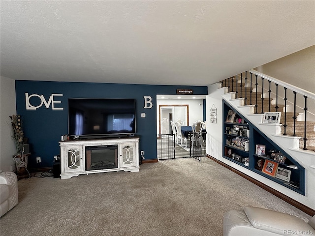 495 E Ave, Limon, CO 80828 - living area with carpet floors, stairway, and baseboards