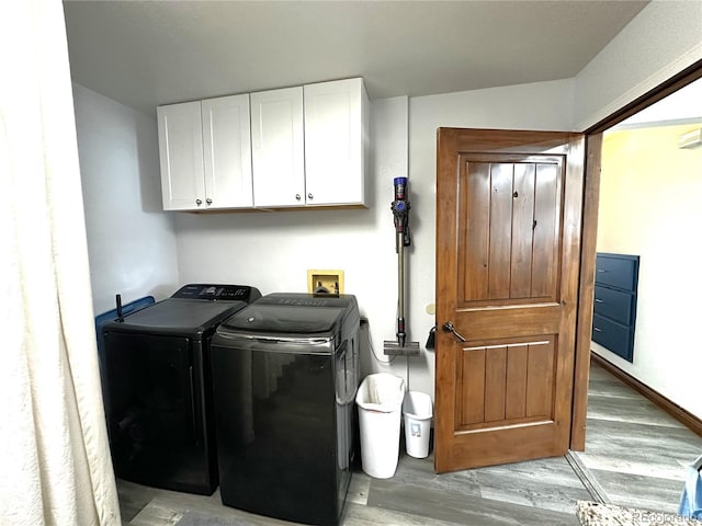 495 E Ave, Limon, CO 80828 - laundry area featuring cabinet space, washer and clothes dryer, and wood finished floors
