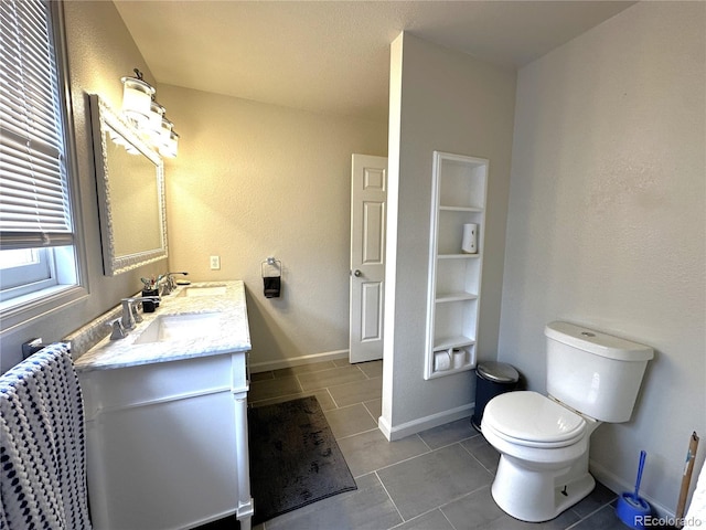 495 E Ave, Limon, CO 80828 - bathroom featuring baseboards, tile patterned flooring, toilet, and vanity
