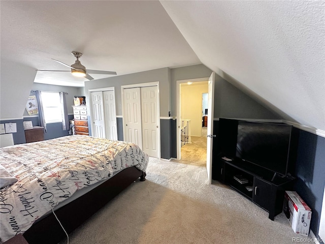 495 E Ave, Limon, CO 80828 - bedroom with two closets, light colored carpet, vaulted ceiling, ceiling fan, and a textured ceiling