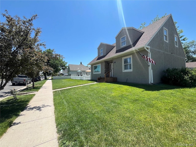 495 E Ave, Limon, CO 80828 - view of side of home with a yard, roof with shingles, and stucco siding