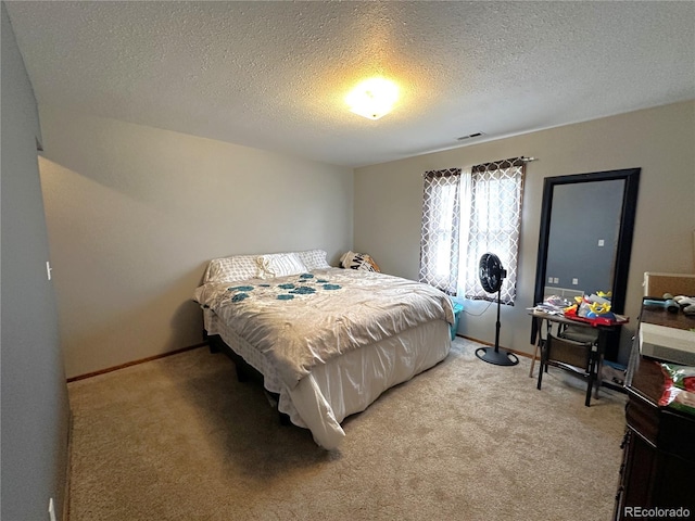 495 E Ave, Limon, CO 80828 - bedroom featuring light colored carpet and a textured ceiling