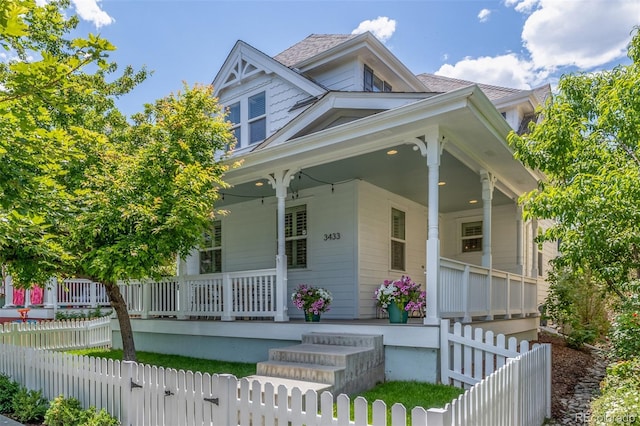 3433 N Wabash St, Denver, CO 80238 - view of front of property with covered porch, a fenced front yard, and a gate