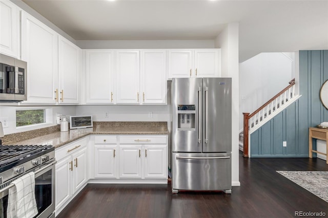 3433 N Wabash St, Denver, CO 80238 - kitchen featuring appliances with stainless steel finishes, dark wood finished floors, white cabinetry, and stone countertops