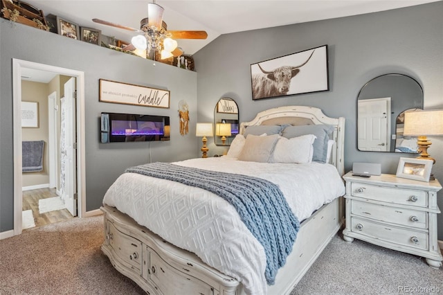 bedroom with lofted ceiling, ceiling fan, connected bathroom, carpet floors, and baseboards