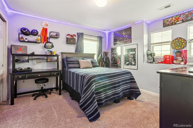 carpeted bedroom with visible vents and baseboards