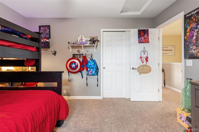 carpeted bedroom with baseboards and a closet