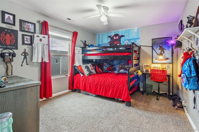 carpeted bedroom featuring baseboards, visible vents, and a ceiling fan