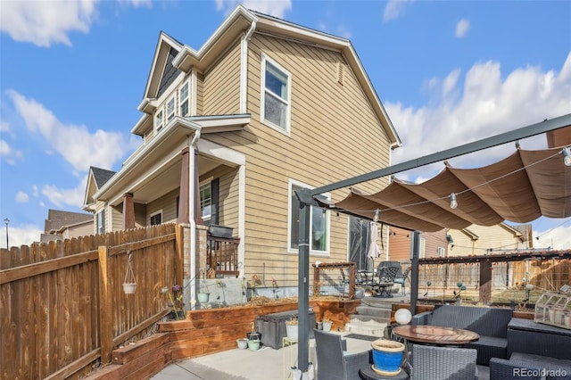 rear view of house featuring a pergola, fence, and a patio