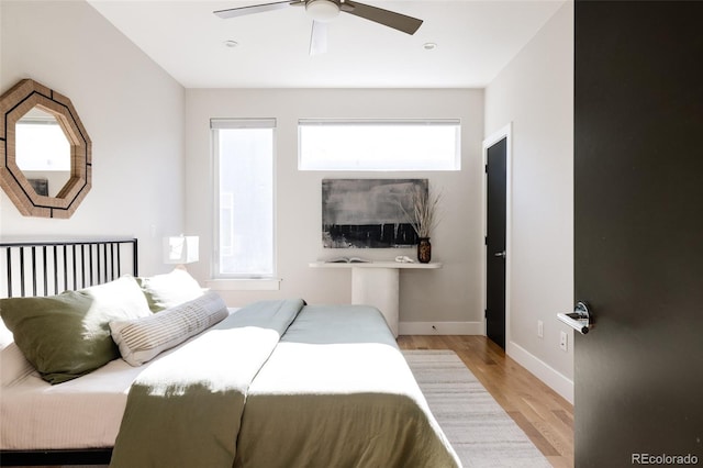 bedroom with ceiling fan and light hardwood / wood-style flooring