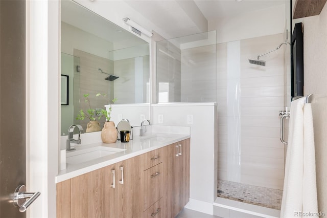 bathroom with vanity and tiled shower