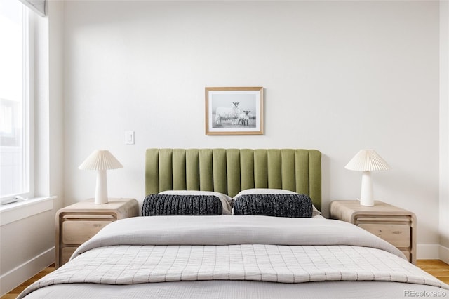 bedroom featuring hardwood / wood-style floors and multiple windows