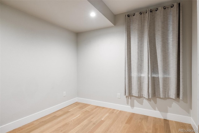 spare room with hardwood / wood-style flooring