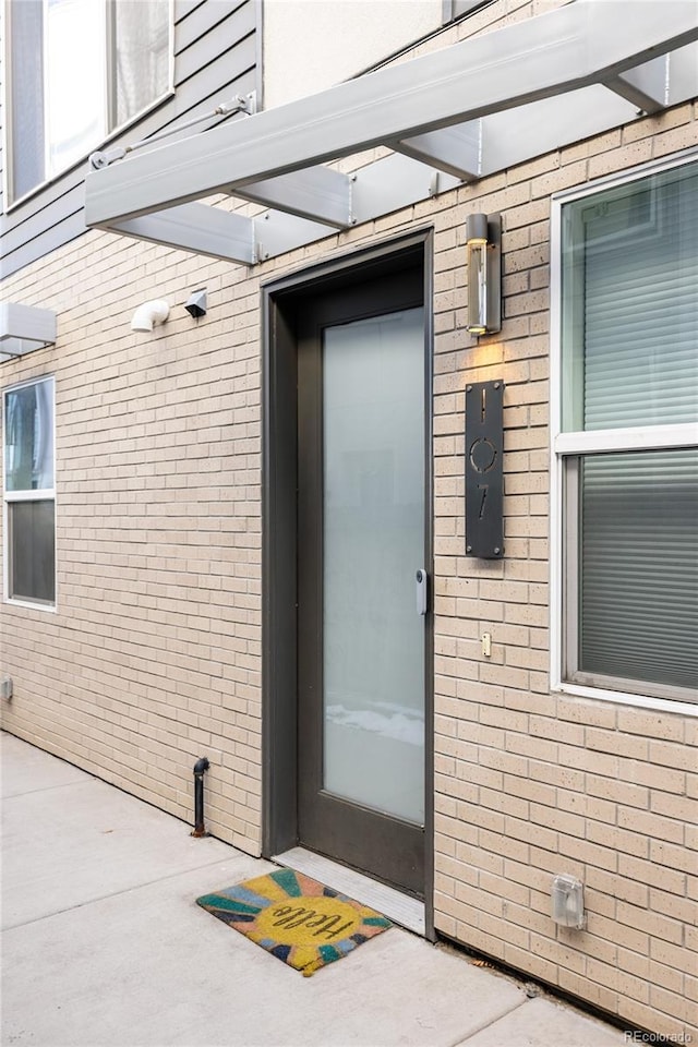 property entrance featuring a patio