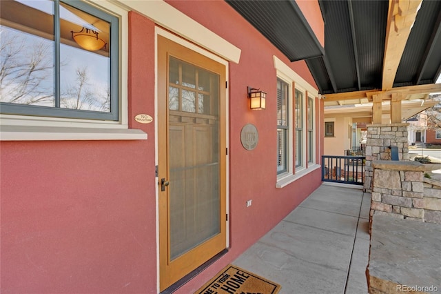 view of exterior entry with a porch