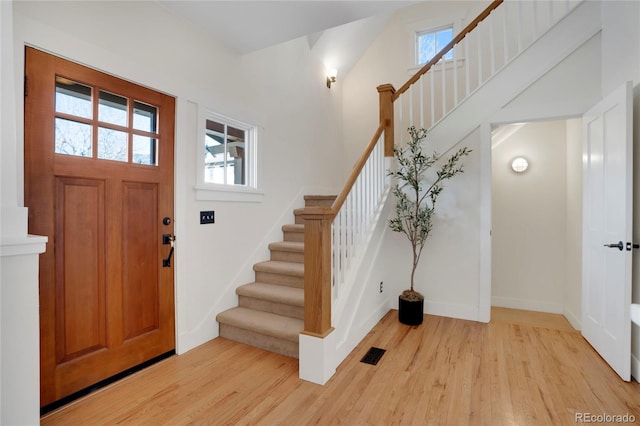 foyer featuring a wealth of natural light and light hardwood / wood-style flooring