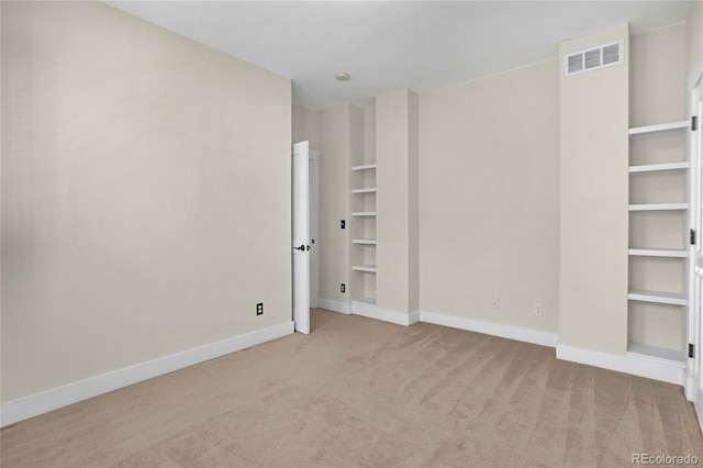 spare room featuring light colored carpet