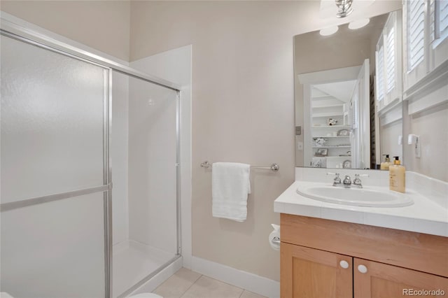 bathroom with tile patterned floors, an enclosed shower, and vanity