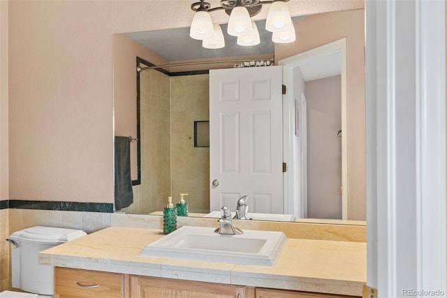 bathroom featuring vanity, toilet, and tile walls