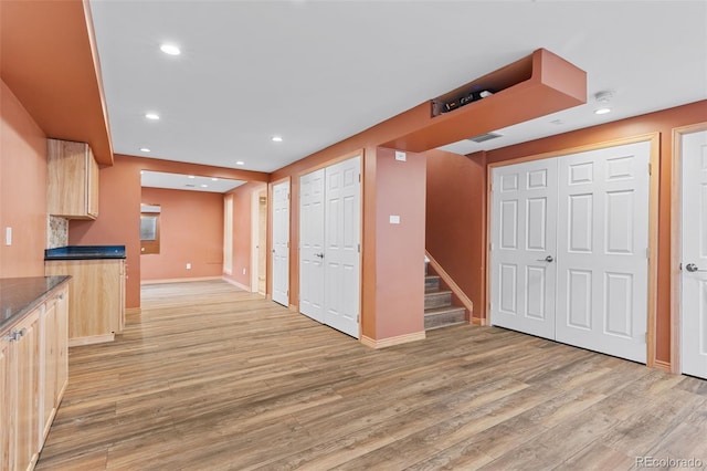 kitchen with light brown cabinetry, light wood-style floors, recessed lighting, and baseboards