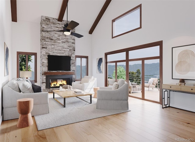 living area featuring a healthy amount of sunlight, a fireplace, and wood finished floors