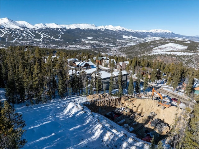 snowy aerial view featuring a mountain view