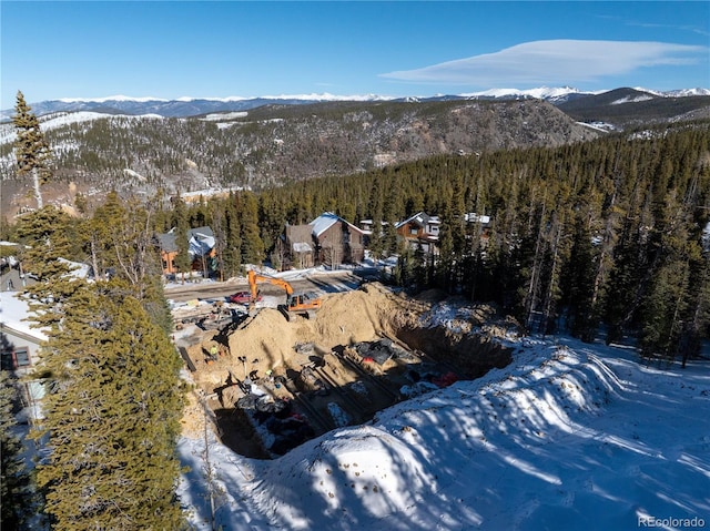 aerial view with a wooded view and a mountain view