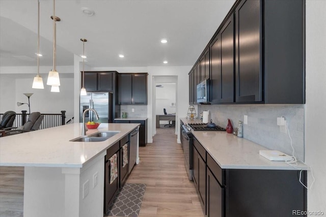 5045 Preserve Pl, Firestone, CO 80504 - kitchen with stainless steel appliances, decorative backsplash, light wood finished floors, decorative light fixtures, and light stone counters