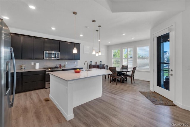 5045 Preserve Pl, Firestone, CO 80504 - kitchen featuring appliances with stainless steel finishes, light wood-type flooring, light countertops, decorative backsplash, and recessed lighting